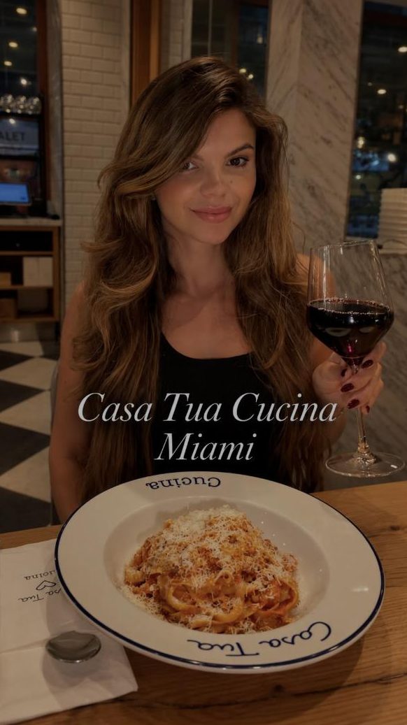Juliana with red wine and pasta at Casa Tua Cucina