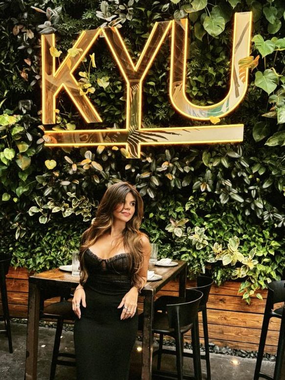 Juliana under the KYU neon sign in Wynwood