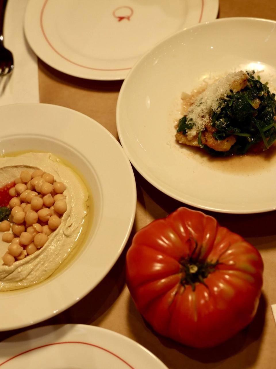 Hummus, spinach with parmesan and an heirloom tomato at Naked Tomato