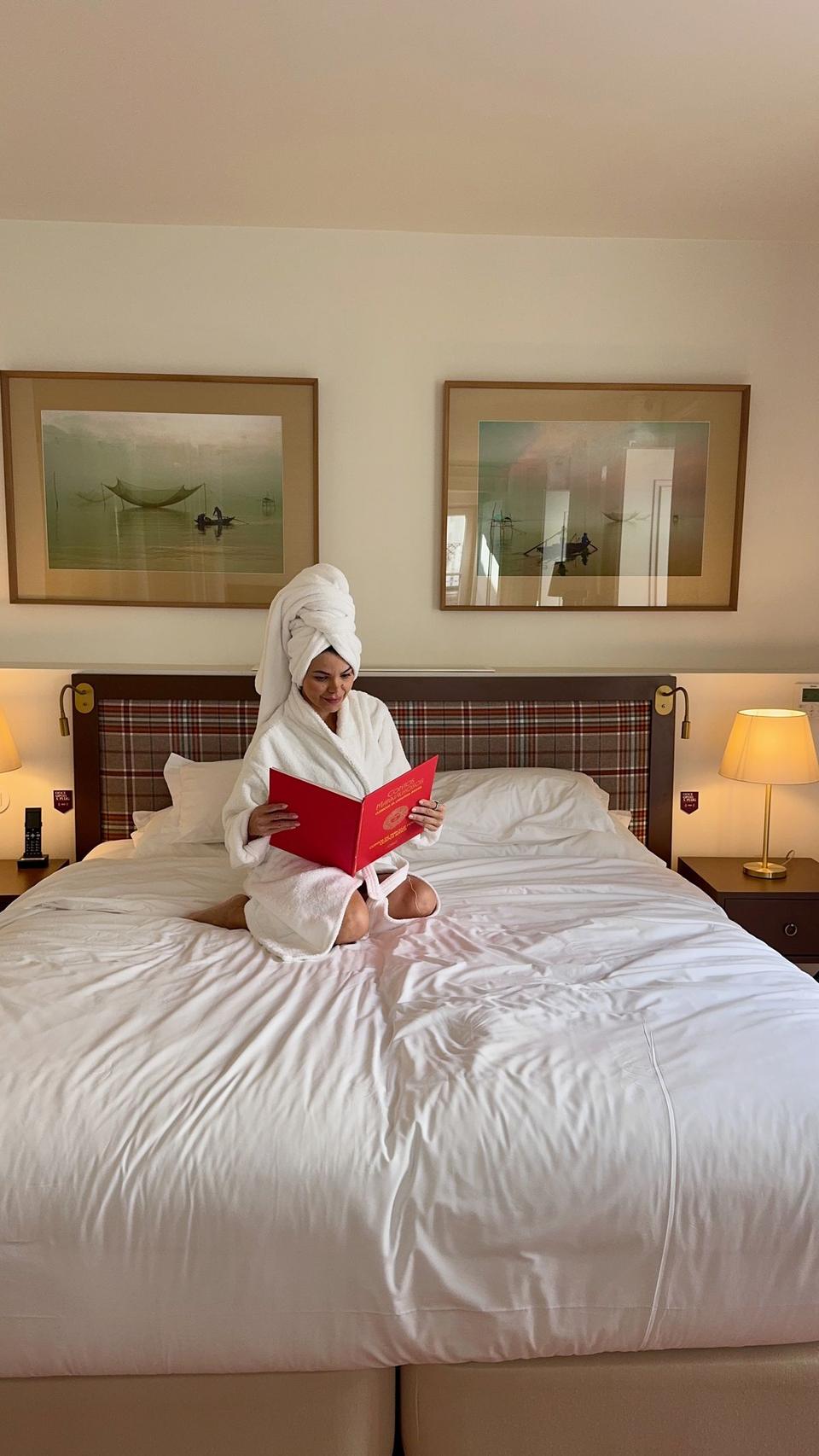 Juliana reading on the bed at Once Upon Lisboa